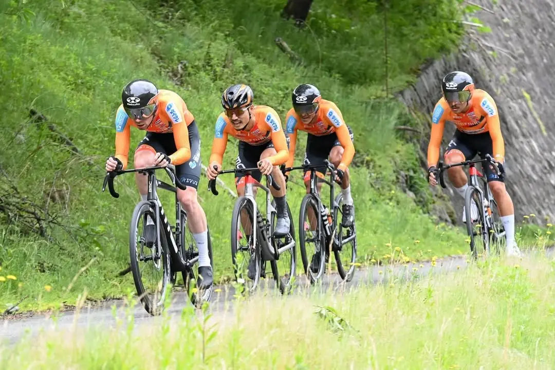 A cyclist racing on Particle carbon wheels aero riding posture